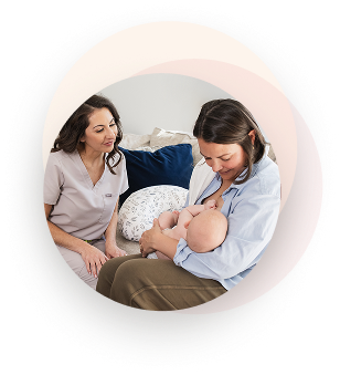 Lauren supports a mother breastfeeding her baby during an in-home lactation consultation